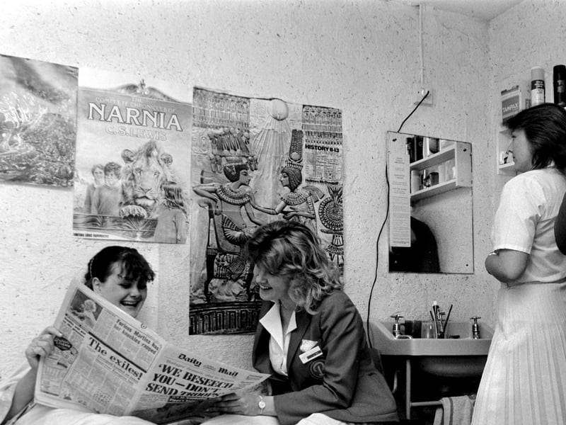 A group of Redcoats in a staff chalet prepare their hair and clothing ready for duty at the Butlin's Holiday Camp in Bognor Regis, West Sussex, in June 1985