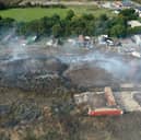 Smoke over the illegal waste site after the burning of waste. Residential properties are in view nearby.