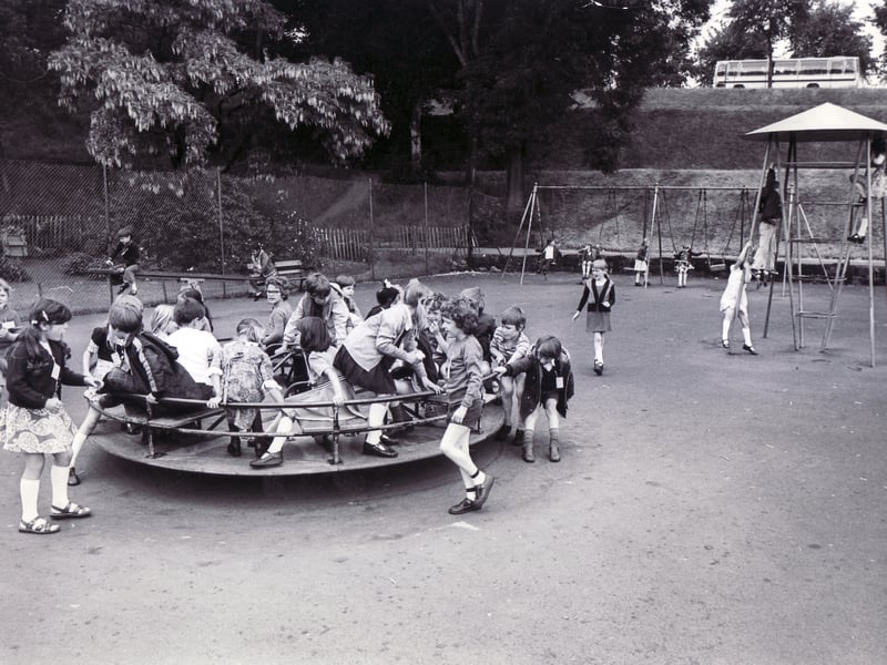 Youngsters cram onto a roundabout at the playground in Crookes Valley Park, Sheffield, in June 1976