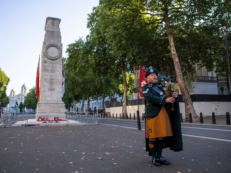 Lance Corporal James Bell plays the bag pipes in front of the Cenotaph to commemorate Victory in Japan Day. 