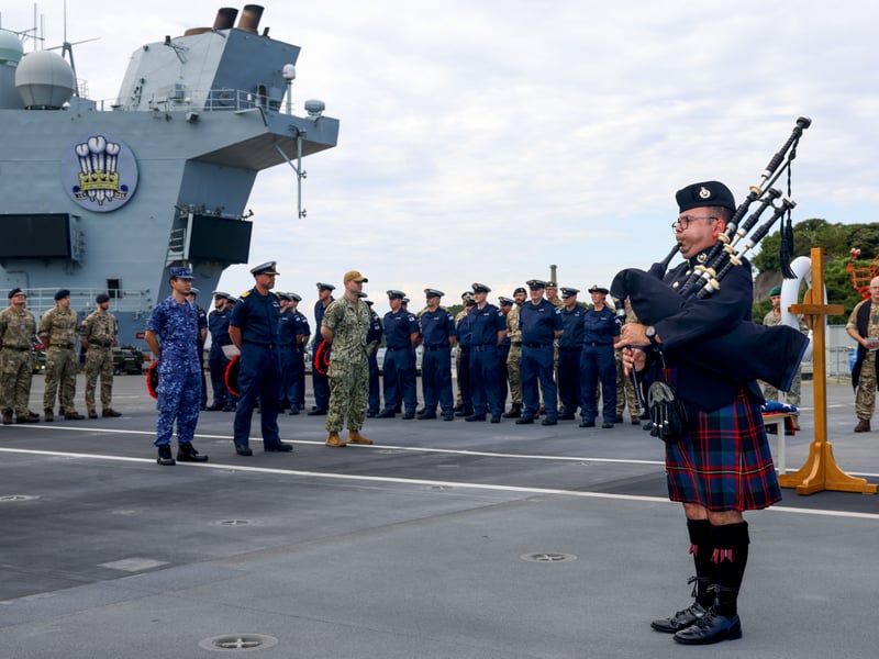The ship's company of HMS Prince of Wales, accompanied by the Chaplain from HMS Dauntless, gathered on the flight deck to mark the end of the Second World War and pay respects to all those who lost their lives.