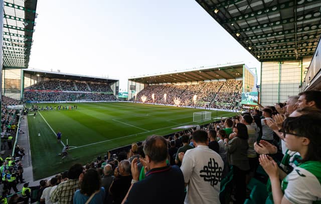 A sold-out Easter Road welcome the teams onto the park.