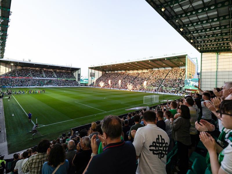 A sold-out Easter Road welcome the teams onto the park.