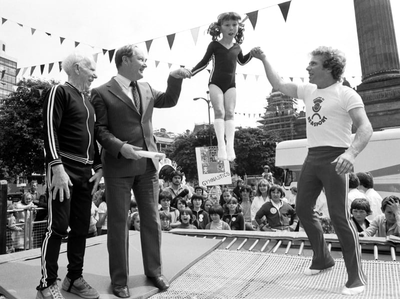 Scottish trampolining champion Ian Hamilton (right) helps a little girl on the trampoline in George Square, Glasgow, at the launch of the Sport For All campaign in July 1979