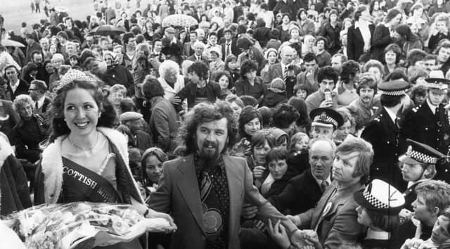 Comedian Billy Connolly pictured with the Scottish Coal Queen Miss Sandra Carruthers, of Cumnock, during the heyday of the Scottish Miners' Gala in Edinburgh, on June 12, 1976