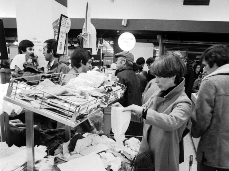 With her baby asleep in the buggy, a mother gets a chance to rummage in the Boxing Day sales on Glasgow's Argyle Street in 1978