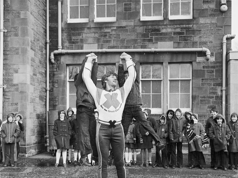 The Green Cross Code man, David Prowse, lifts two boys at Craiglockhart Primary School in Edinburgh. The actor, bodybuilder and weightlifter would go on to play Darth Vader in the original Star Wars trilogy.