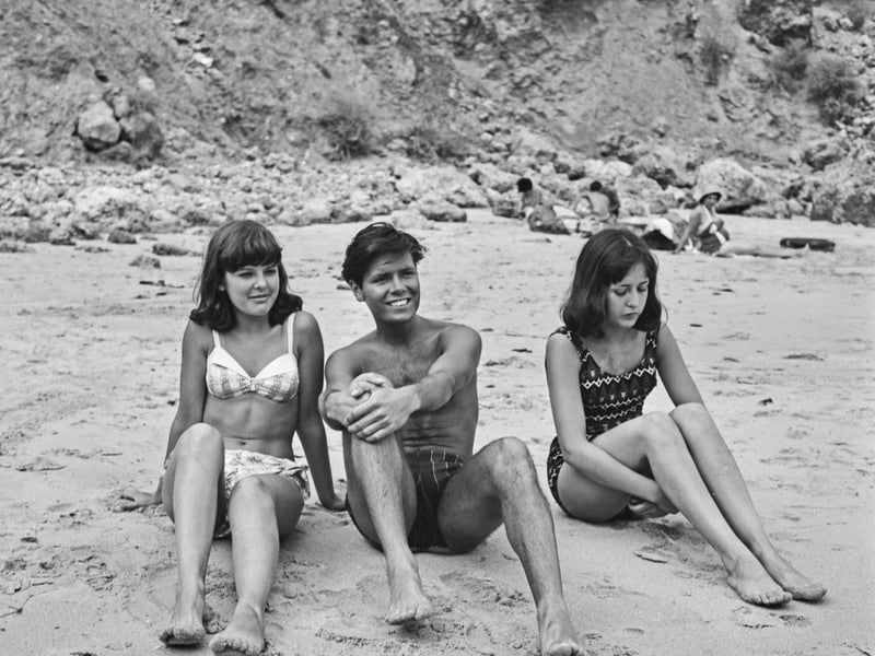Cliff Richard with two of his sisters at the beach in August 1964