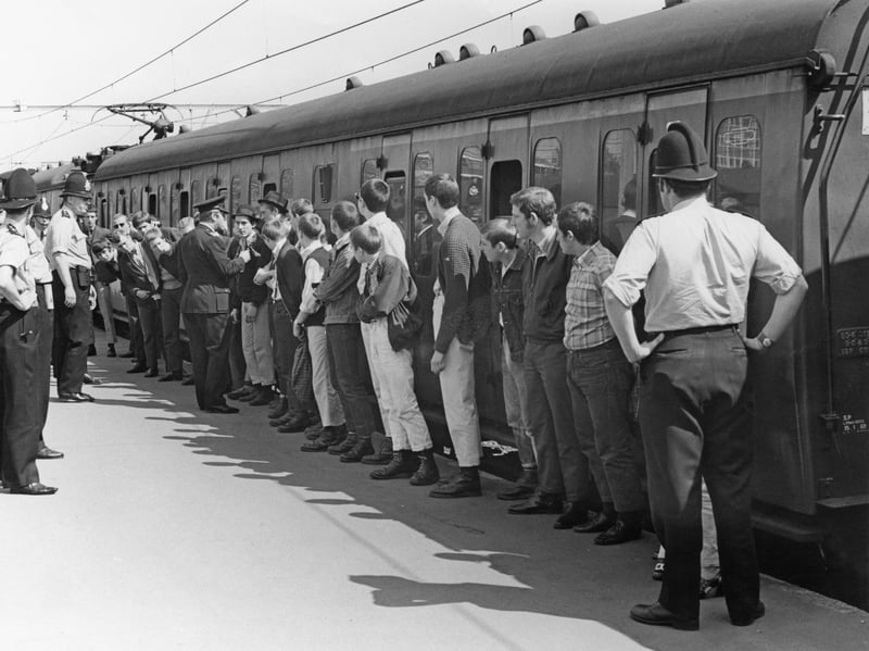 Skinheads arriving at Southend Victoria railway station in May 1970 are lined up to receive advice from police not to get into groups of three or more during their spring bank holiday visit to the seaside town