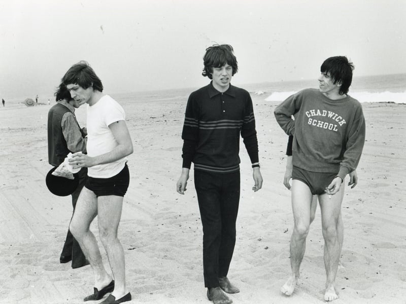 Members of the Rolling Stones walk together on the beach in West Wittering in the mid to late 1960s. Pictured are Charlie Watts, Mick Jagger and Keith Richards, who lived nearby.