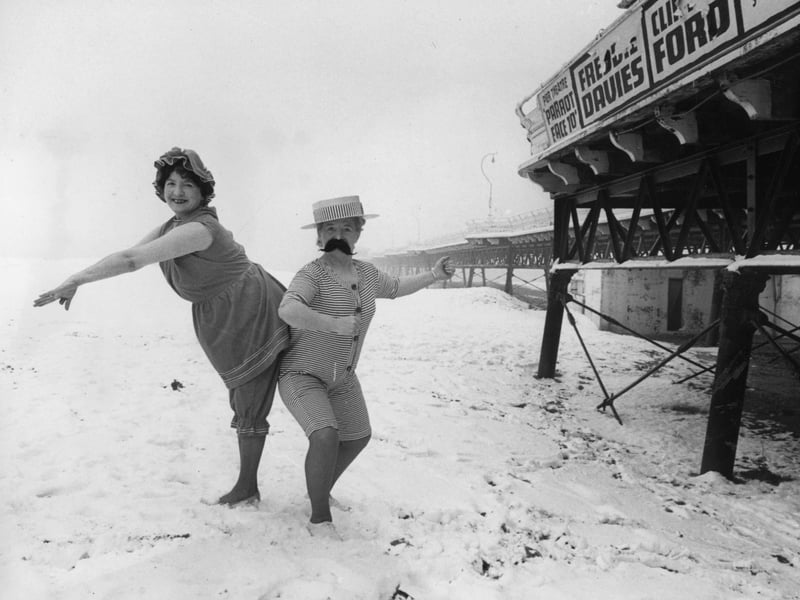 Skegness landladies Hazel Adams and Marjorie Romanis pose on the beach in 1914 bathing costumes, amid the snow, for publicity photographs, in around 1975