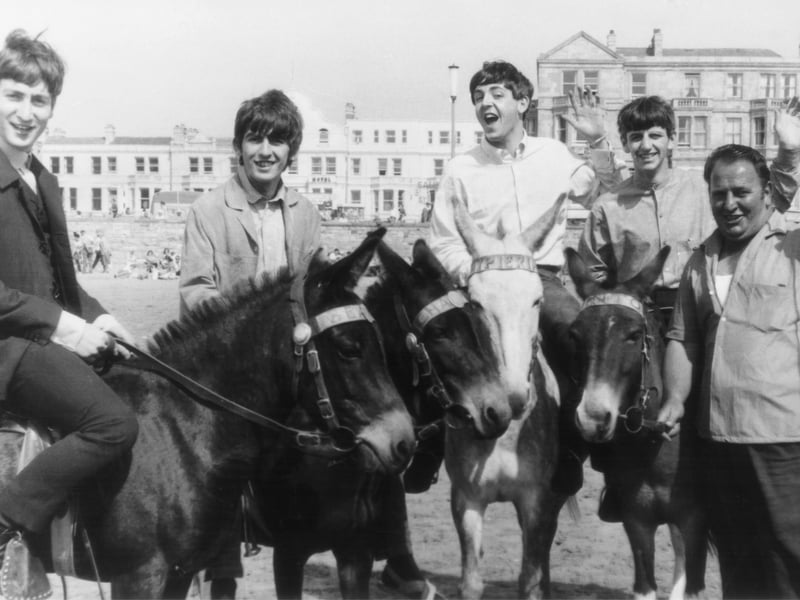 The Beatles ride donkeys on the beach at Weston-super-Mare before a concert in July 1963. The man on the right is the donkeys' owner.