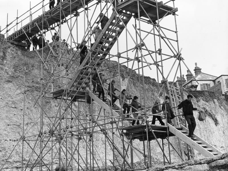 People climb down scaffolding steps to the beach at Birling Gap, Sussex, erected to strengthen the cliffs after cliff falls, in 1972