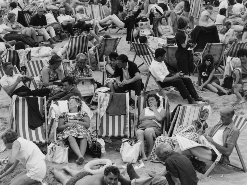 Holiday crowds relax on the beach at Margate, Kent, in  July 1964