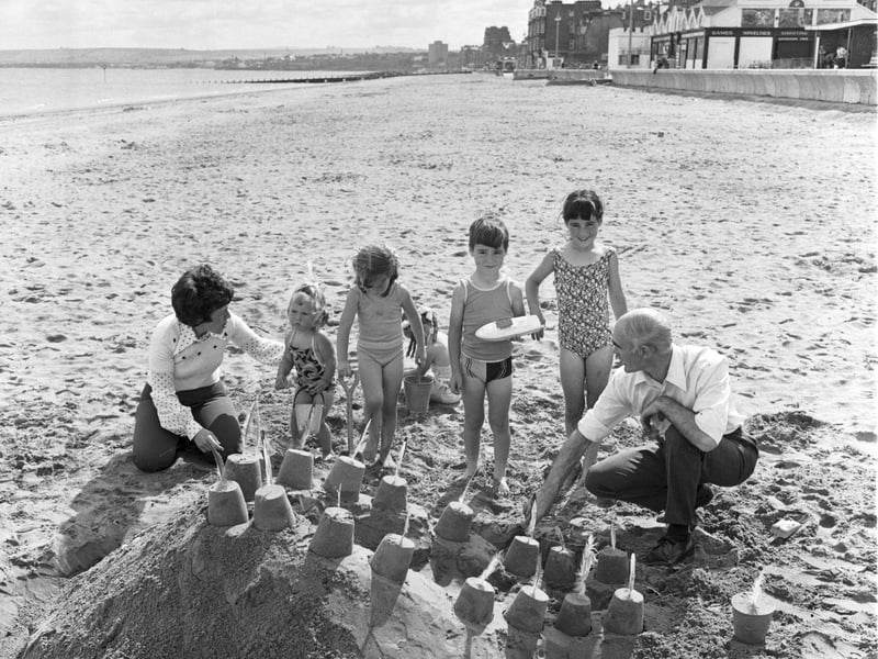 Children building a sandcastle on Portobello beach, Edinburgh, in the summer of 1975