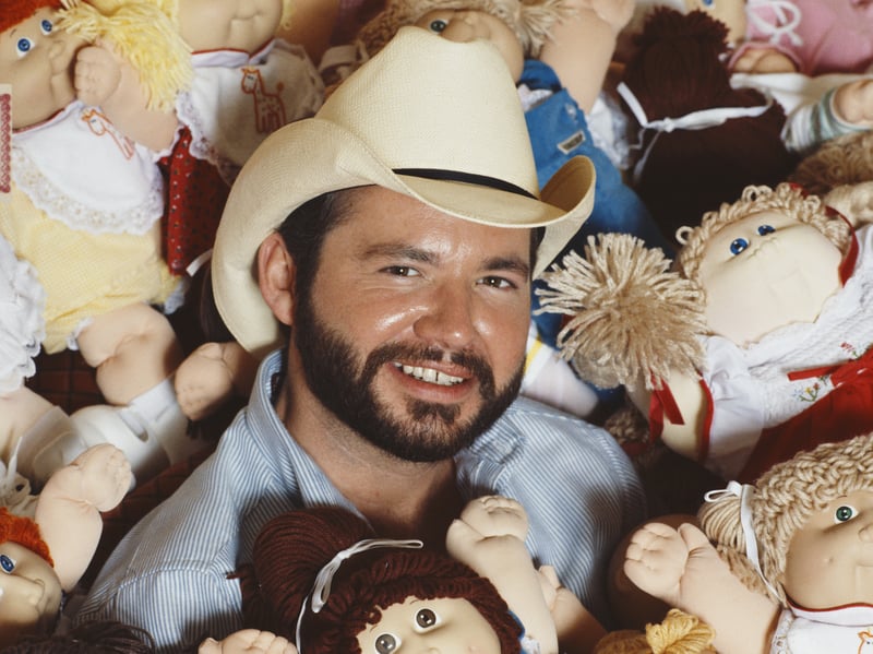 Cabbage Patch Doll creator Xavier Roberts surrounded by the popular toys in December 1983