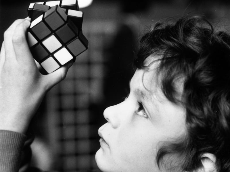 10-year-old Terry O'Neill tries to solve a Rubik's Cube at the British Toy and Hobby Fair in February 1981. The puzzle was one of the best-selling toys of the 80s.
