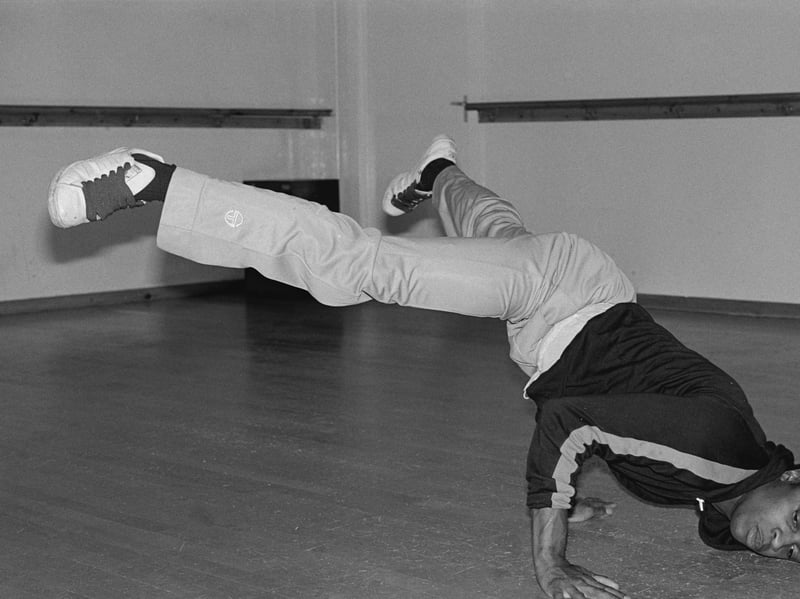 A hip hop dance instructor and breakdancer demonstrates power moves at London's famous Pineapple Dance Studios in 1985