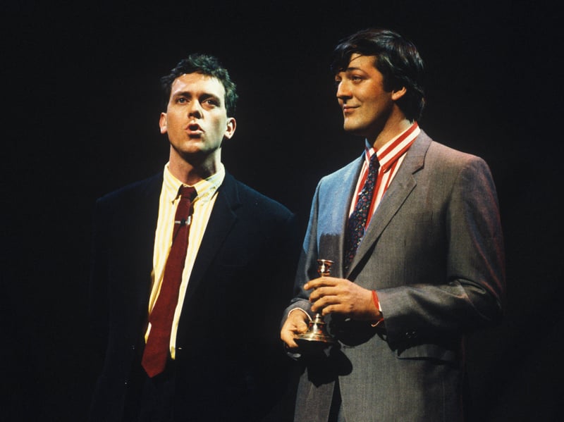 Sir Stephen Fry is pictured here with regular collaborator Hugh Laurie, on stage at a Secret Policeman's Ball benefit show in 1987, aged 29. He made his name as part of a double act with Laurie. His TV work includes their hilarious sketch show A Bit of Fry & Laurie, Blackadder, and the comedy quiz show QI, which he hosted. He has also appeared in numerous films, won acclaim for his stage work and written a number of books.