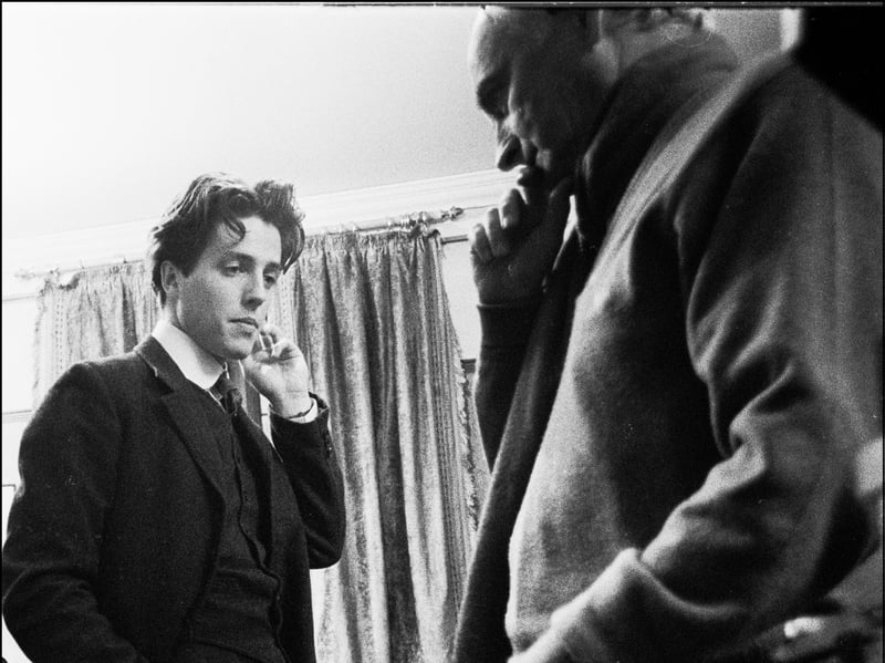 Hugh Grant is pictured here in 1986, aged 25 or 26, filming Maurice' on location at King's College, Cambridge, with director James Ivory. He made his feature film debut in 1982 but it was the 1994 romantic comedy Four Weddings and a Funeral which made him a household name. Having built a reputation for playing affable but bumbling romantic leads, in recent years he has acted against type, playing a number of villains and appearing in horror and action films as well as dramas and comedies.