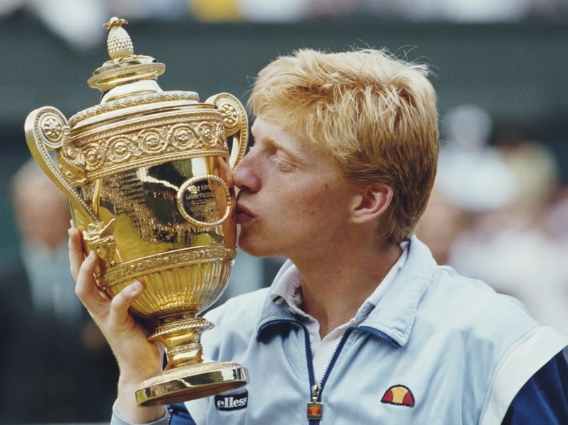 A 17-year-old Boris Becker kisses the trophy to celebrate winning his first Wimbledon title, after beating Kevin Curren in the 1985 final