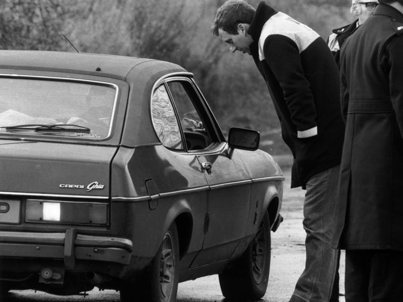 An NUM official talks to the driver of a Ford Capri Ghia on the picket line during the miners' strike, in November 1984