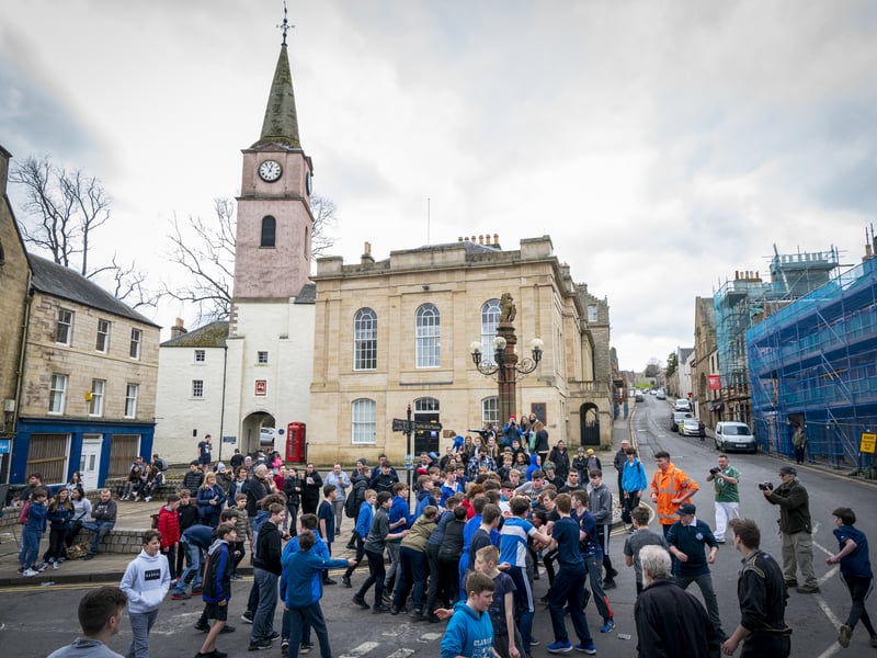 Jedburgh is a town and former royal burgh in the Scottish Borders. It is dominated by the ruins of Jedburgh Abbey and other notable buildings include Queen Mary's House, Jedburgh Castle Jail, now a museum, and the Jedburgh Library. Pictured is the annual Jedburgh Ba' game where boys tussle for a leather ball.