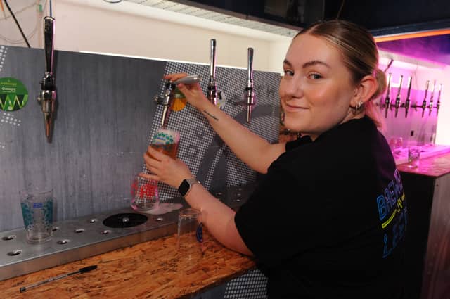Bar supervisor Kathrine Miller keeps the beers flowing.