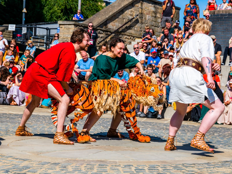 An re-enactment group entertaining the crowds  in the outdoor amphitheatre demonstrating their show Androcles and the Tiger.
