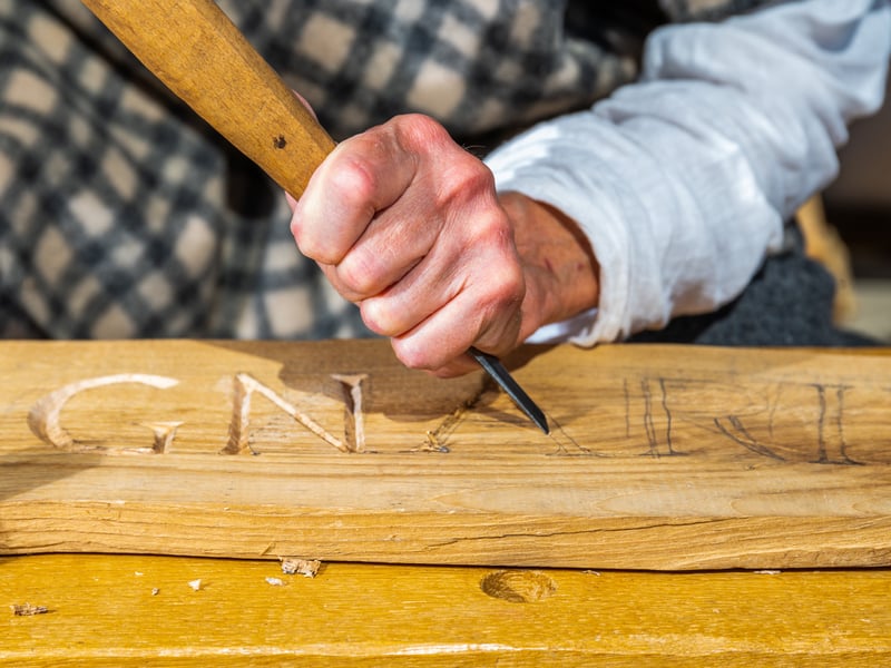 Hugh Milton, part of the Griffin Historical Group, dressed as a Roman Woodworker giving demonstration to weekend visitors of his craft during the Roman Festival.