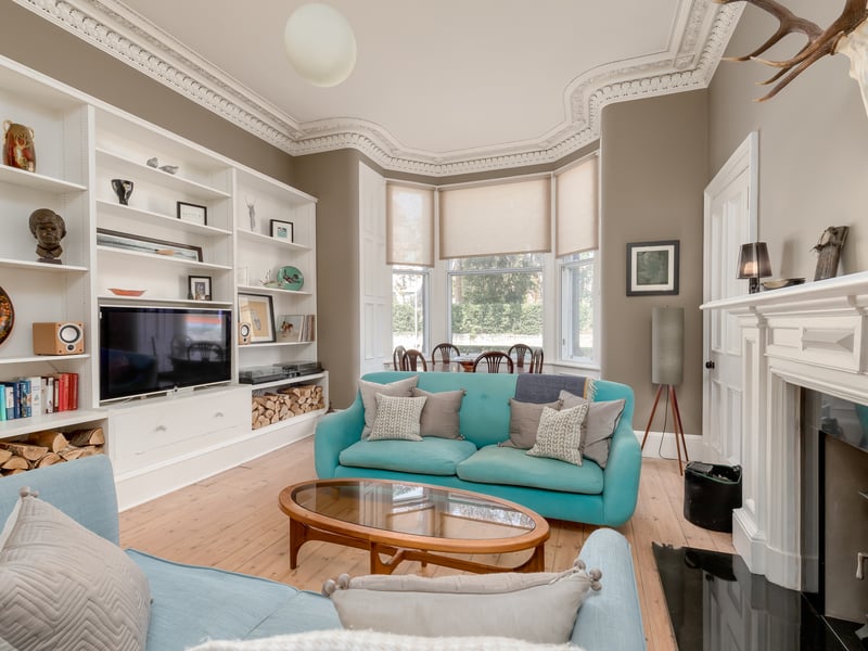The sitting room also features a bespoke built-in storage wall.