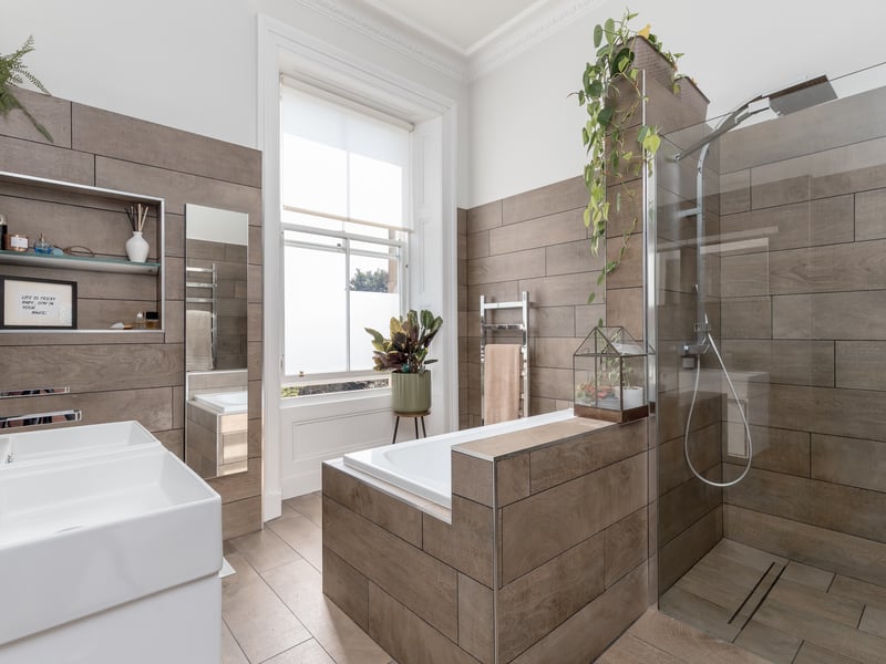 The large family bathroom includes a walk in shower and separate built-in bath. 