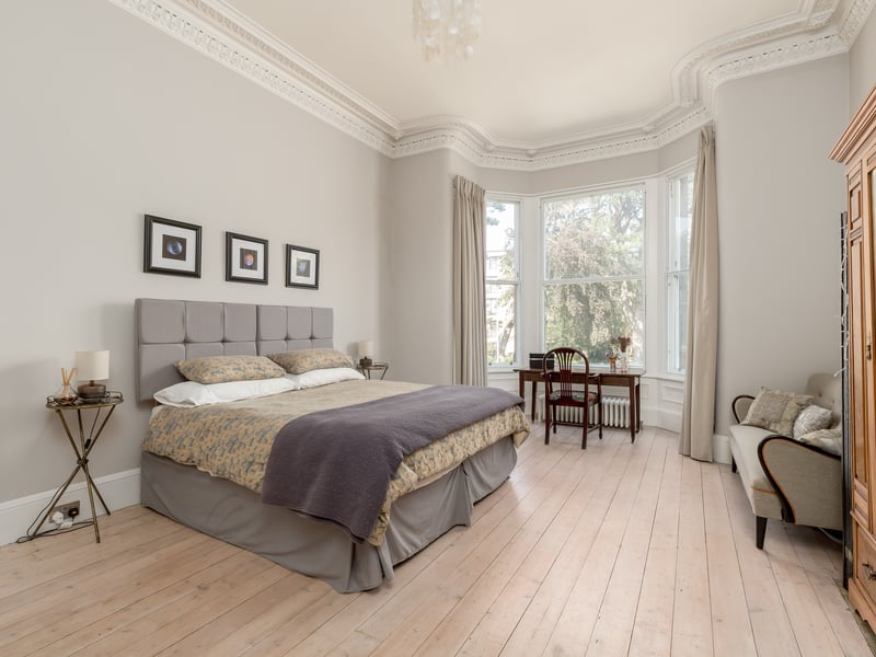 The principal bedroom features preserved original wooden flooring