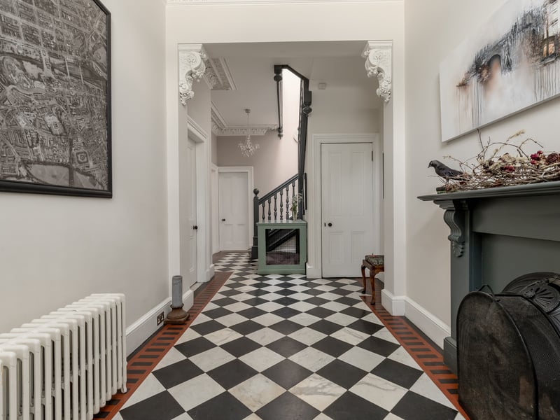 The broad reception area is complete with the original fireplace. 