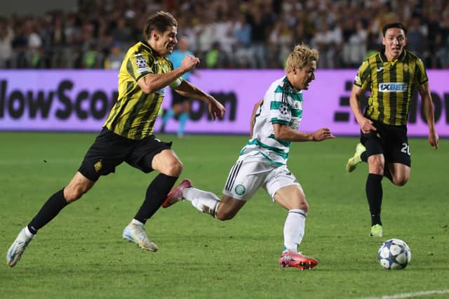 Celtic's Daizen Maeda, centre, controls the ball while Kairat's Aleksandr Martynovich, left, and Yerkin Tapalov chase him.