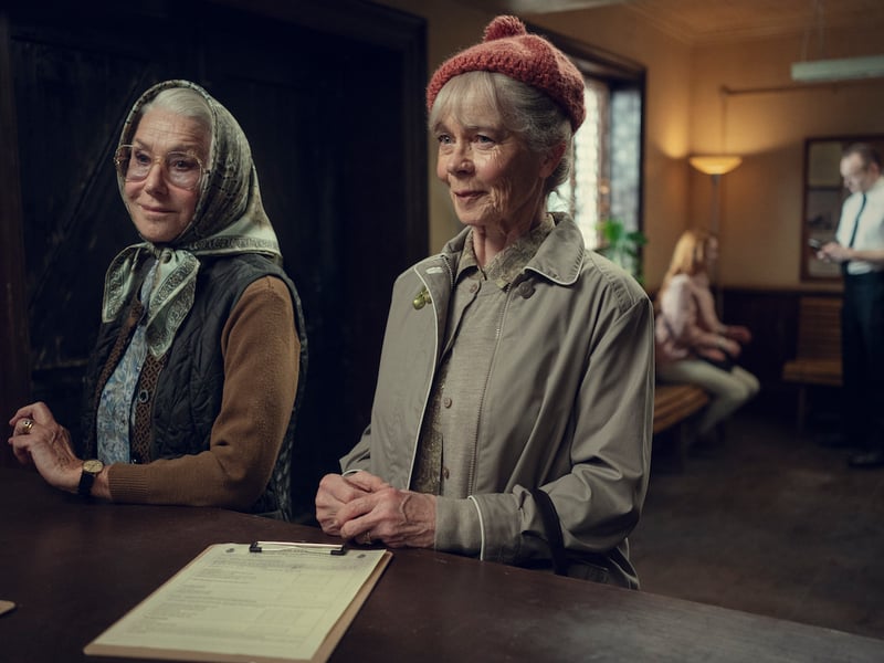 In the book, through one of her diary entries, Joyce explains how Elizabeth came to her looking for medical advice and that is how she was roped into the club. For the film, she stumbles into the Jigsaw Room while they are in session and catches Liz’s attention.