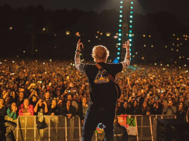 Ed Sheeran fans hold their phones aloft as they watch him perform at Roundhay Park, Leeds, during his Divide world tour in August 2019