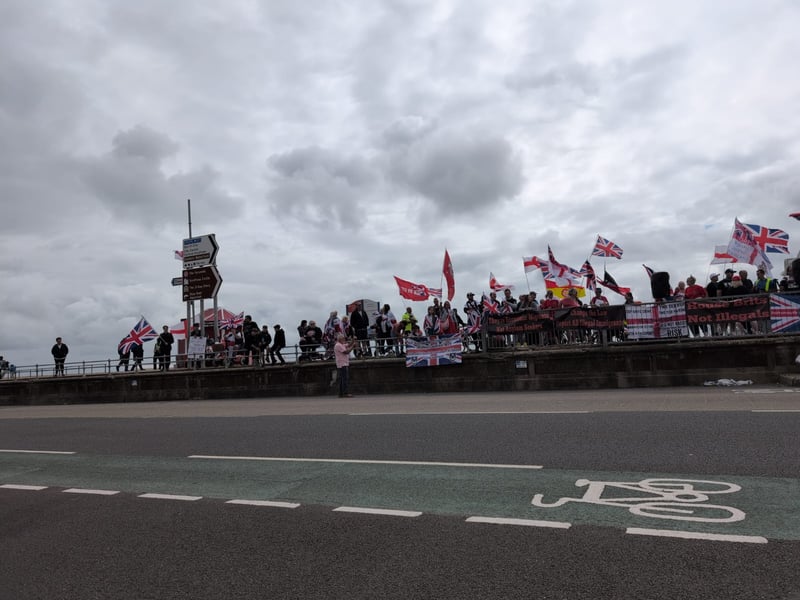 Anti-racism and anti-immigration protestors face each other on Eastney Esplanade near South Parade Pier.