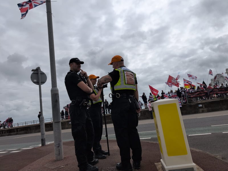 Anti-racism and anti-immigration protestors face each other on Eastney Esplanade near South Parade Pier.