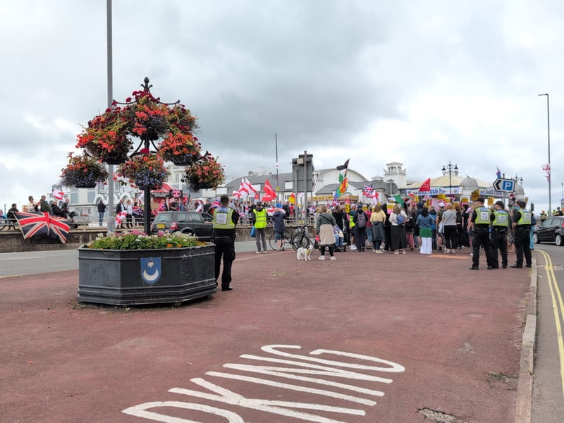 Anti-racism and anti-immigration protestors face each other on Eastney Esplanade near South Parade Pier.