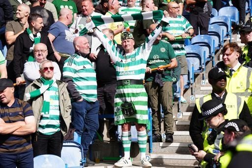 A Celtic fan wearing a kilt with green and white stripes.