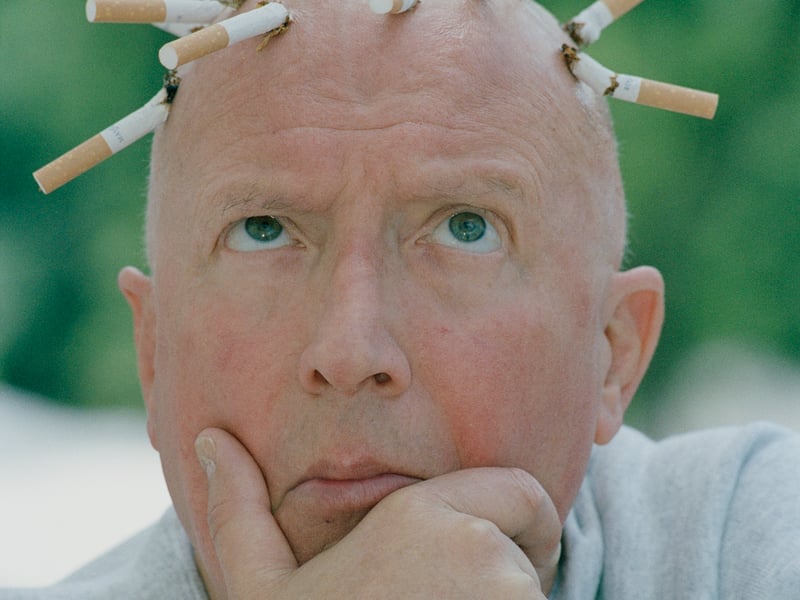 Record Breakers presenter Roy Castle poses with cigarettes stubbed out on his scalp, for the Cancer Research Campaign in July 1992. He was diagnosed with lung cancer earlier that year and sadly died in 1994, aged 62.