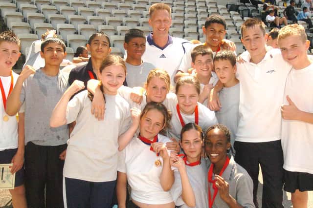 Former Olympic hero and head of PE at Firth Park C.A. College  John Sherwood (centre rear) with some of the pupils who took part in a sports day to mark his retirement .  Photo: Sheffield Newspapers Ltd