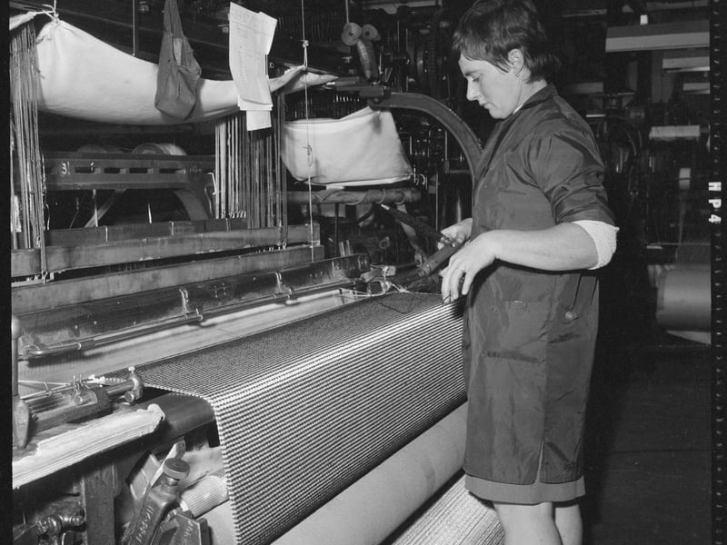 Power looms were developed in Lancashire mills for the mass production of woven cloth in towns like Blackburn and Burnley. This photo shows a weaver preparing a shuttle for use in a power loom