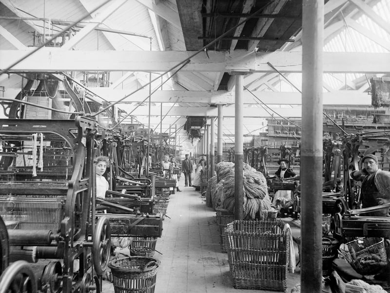 The interior of a loom shed making blankets. After the 1860s, the railway brought coal to the town in large enough quantities for the mills to become steam-powered