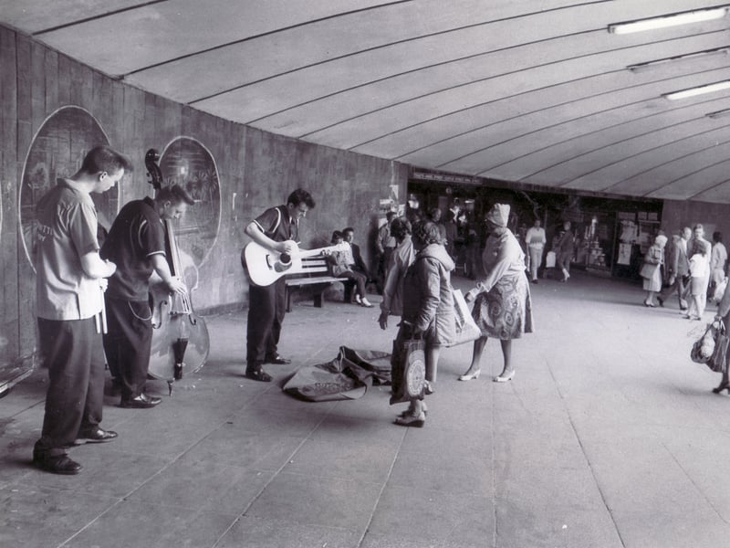 Entertainers were a familiar site. This picture shows The Slingshots entertain shoppers in the Hole in the Road subway in May 1984
