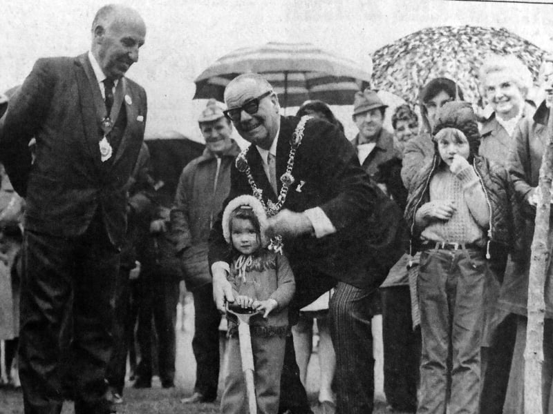 The Lord Mayor of Portsmouth, Cllr Darby, helps two-year-old Anita Moore, of Cosham, plant a tree at the East Hants Caravan Centre ceremony at Southsea Common. Roy Tabb, chairman of the centre, looks on with some of the 200 caravanners enjoying the rally on the common. 