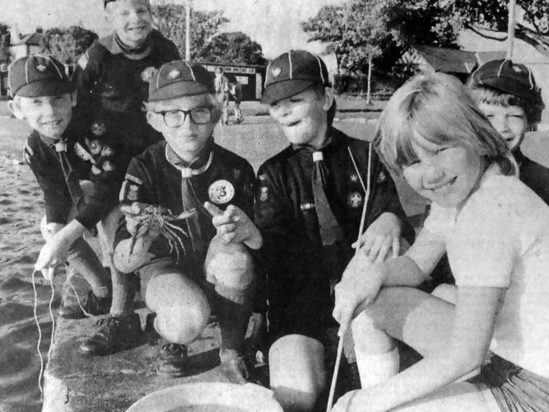 Members of the 8th Portsmouth Cub Scouts pictured fishing for crabs at Canoe Lake, Southsea. Fearless fishermen Paul Jones, 10, is seen showing his latest catch to 10-year-old Amanda Harris, with their friends looking on.