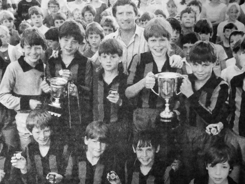 Fernhurst Middle School football champions welcome two visiting managers to their school, Pompey boss Alan Ball and their own team manager, Howard Payne. The Southsea school's under-12 team clinched the League and Cup double, and Alan Ball presented them with the trophies. Pictured is Alan Ball, centre, with Fernhurst Middle School football team. Back row, from left: Tak Lok Lai, Robert Gall, Mark Welch, Stuart Morgan, Brett Flood, Matthew Tilly and Stephen Gillespie. Front row: Lee McLauchlin, Chris Bennett, Dena Maplesden, Paul Griffiths and Wayne Chamberlain.