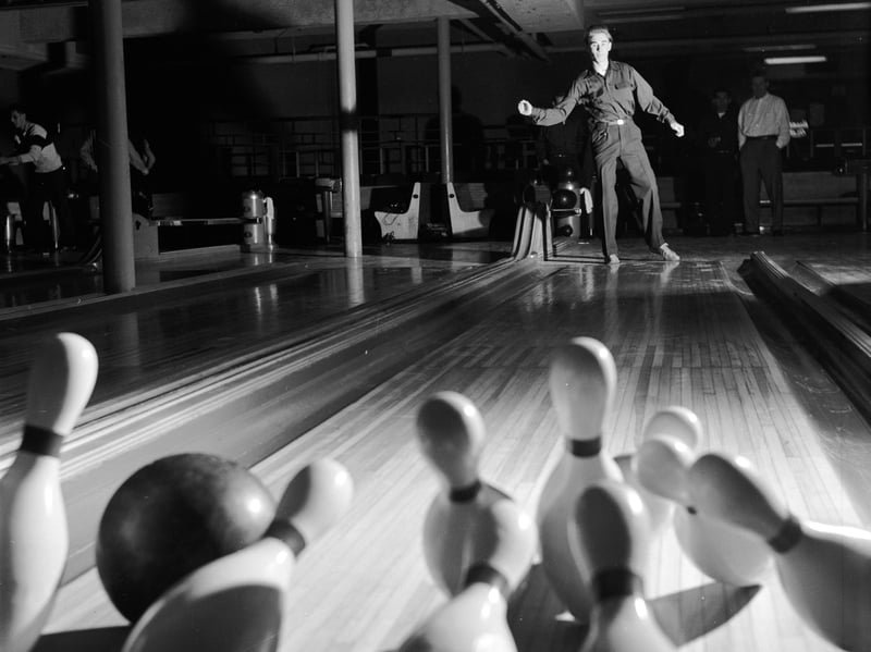 Human pinsetters, or pin boys, were employed at bowling alleys to reset pins and return balls to bowlers. The first mechanical pinsetter was invented in the 1930s, and by the 50s and 60s they had become commonplace.